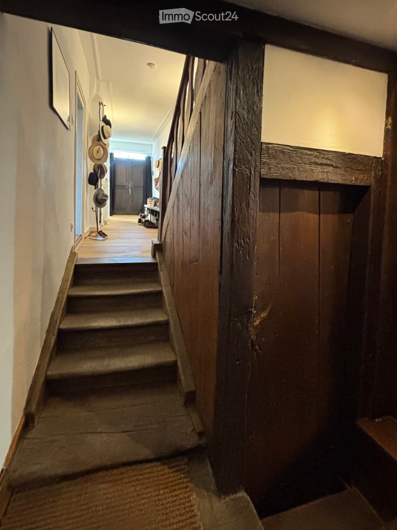 wooden staircase, exposed wooden beams, old wooden bannister