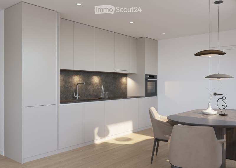 Modern kitchen with white cabinets, a dark countertop, and a sleek faucet. A round dining table with chairs is placed near the center, accompanied by a decorative vase and a modern lamp hanging from the ceiling.