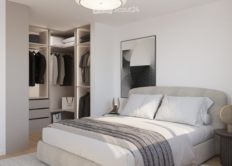 Modern bedroom with a large bed, nightstand, wardrobe, and a stylish picture frame on the wall.