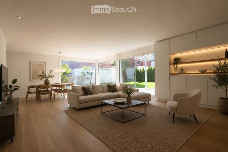 Modern living room with light-colored sofa, coffee table, dining area, pendant light, and large windows overlooking a garden.