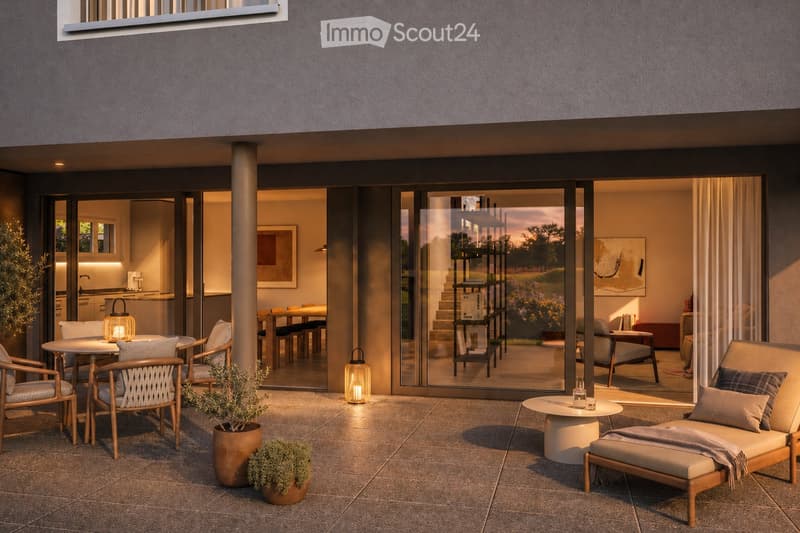 Modern outdoor patio with tiled flooring, lounge chairs, small tables, and potted plants. Large glass sliding doors open to an interior dining area with a table and chairs.