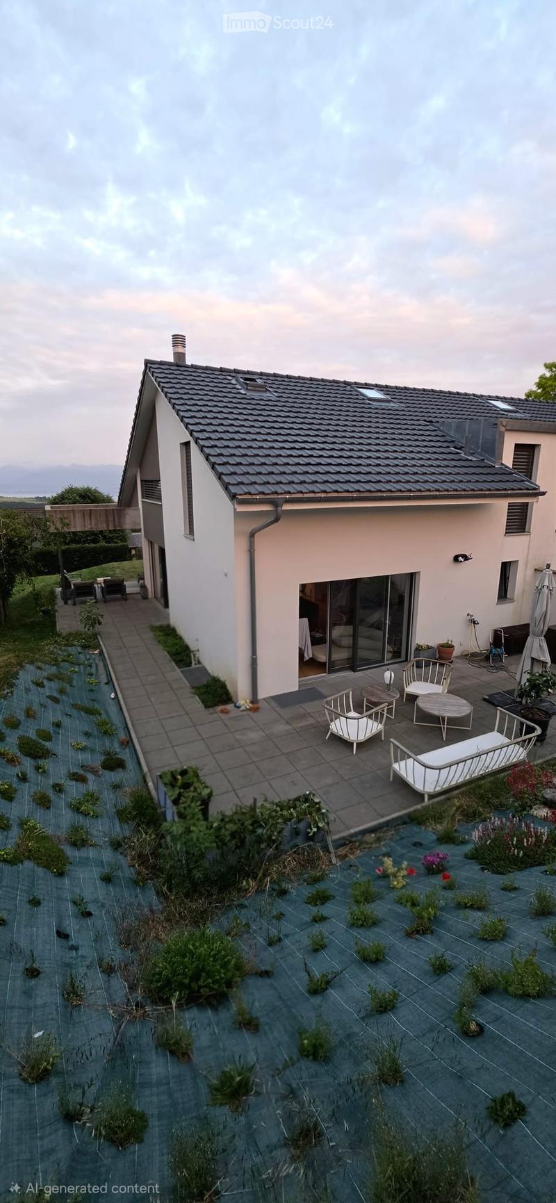 Modern house with a raised garden area, featuring a patio with white furniture, small plants, and a view of the surrounding landscape.