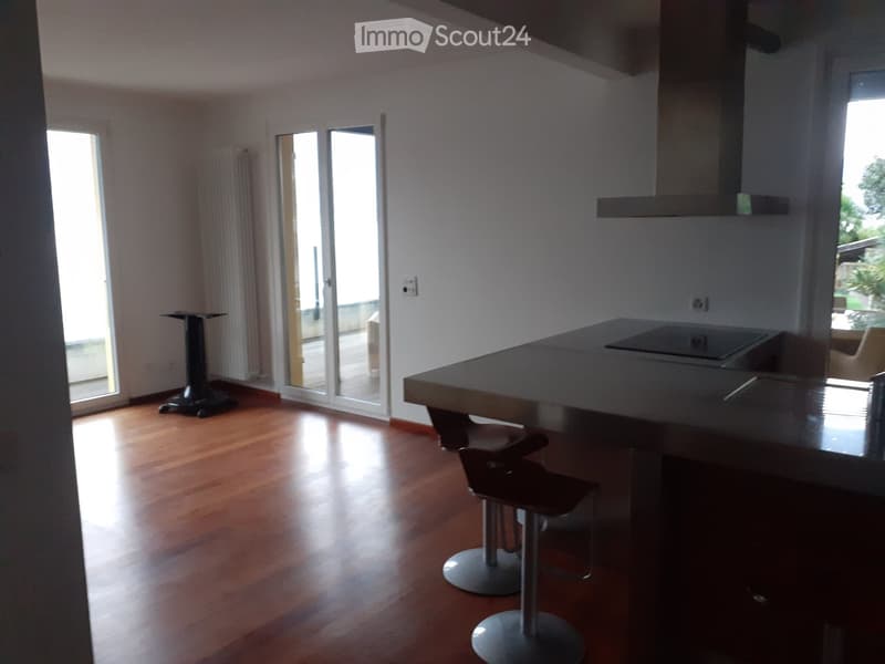 wooden floor, large windows, sliding glass doors, countertop, 2 stools, balcony, view