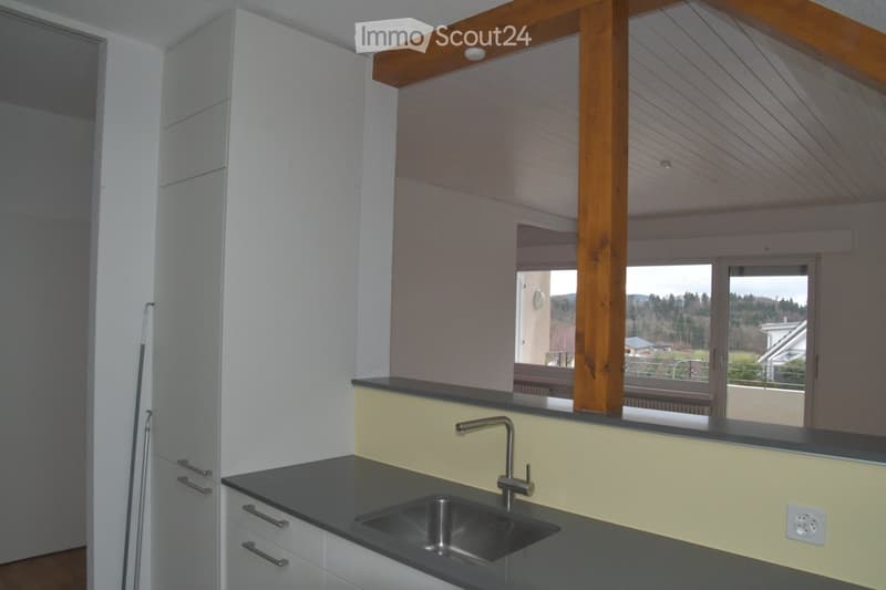kitchen with sink, faucet, cabinets, wooden beam, balcony, window, view of the outside