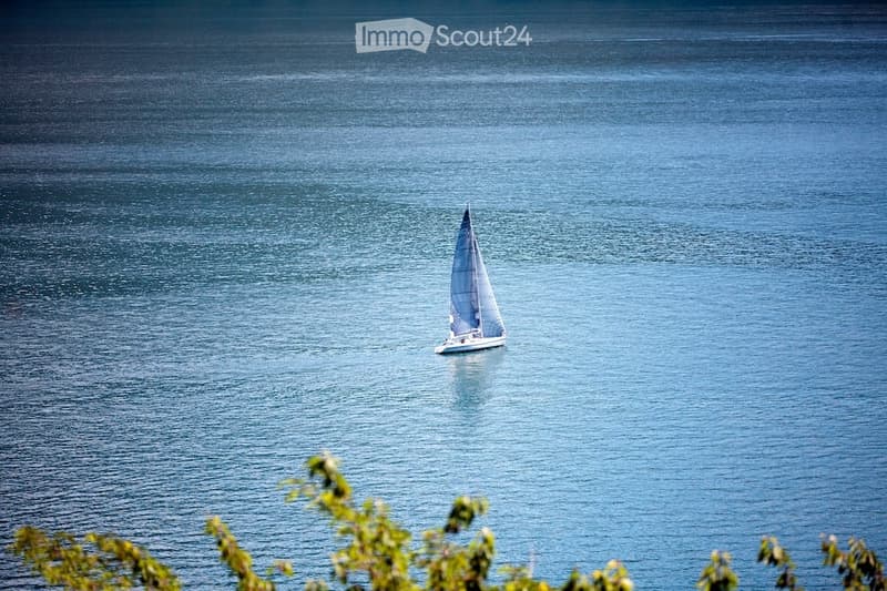 a sailboat sailing on a blue water body