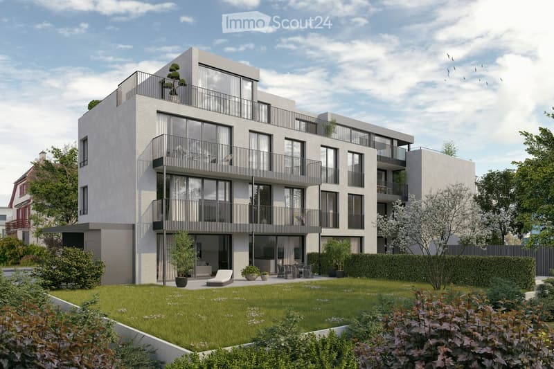 Modern multi-story residential building with balconies, large windows, and a landscaped garden area with lounge chairs and potted plants.