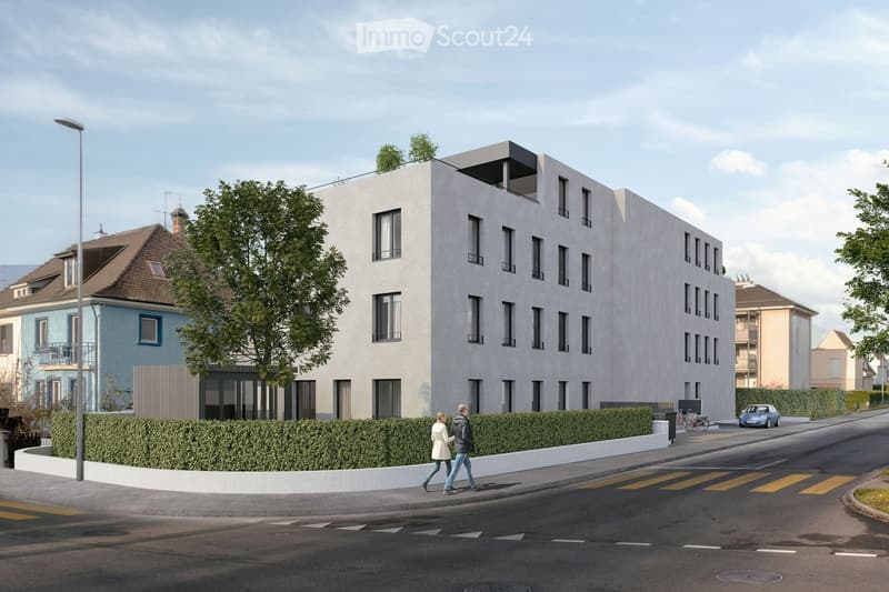 Modern multi-story residential building with white facade and large windows, surrounded by greenery and a pedestrian walkway.