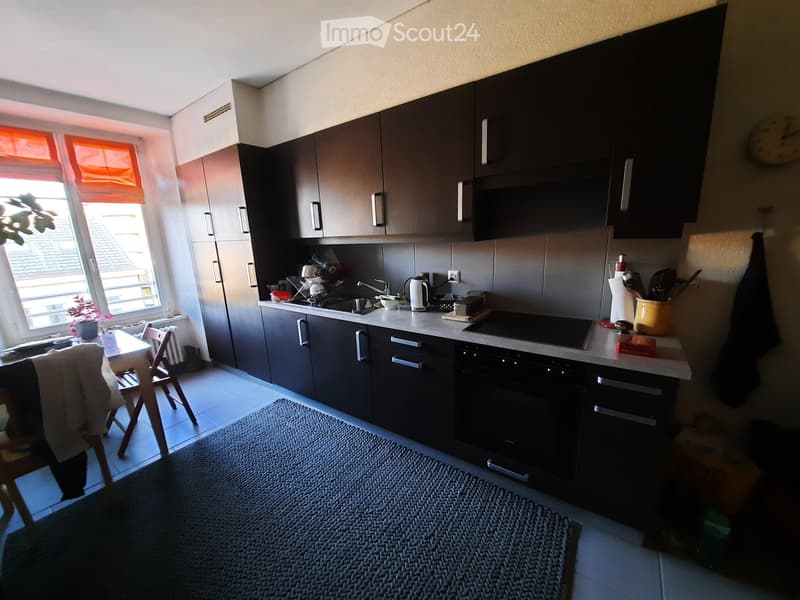 modern kitchen, black cabinets, granite countertops, stainless steel appliances, white tiled floor, large window with curtains