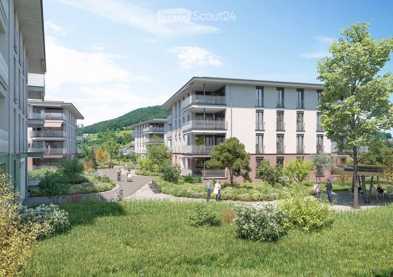 A modern apartment complex with multiple buildings, balconies, and a garden area with people walking and sitting.