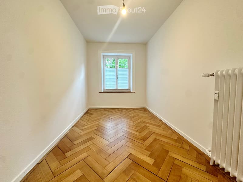 empty room, wooden parquet floor, white walls, window, radiator