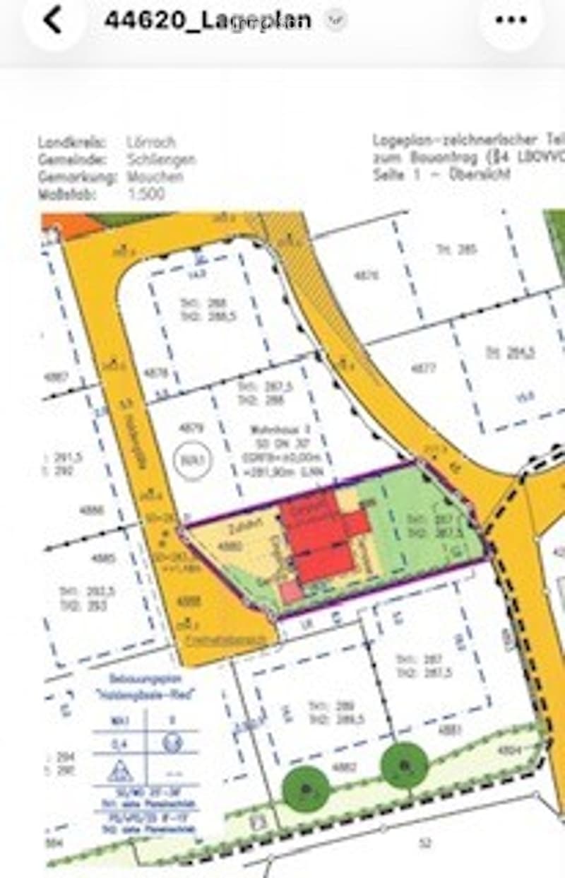 Floor plan of a residential area showing multiple plots, buildings, and designated zones including residential, commercial, and green spaces.