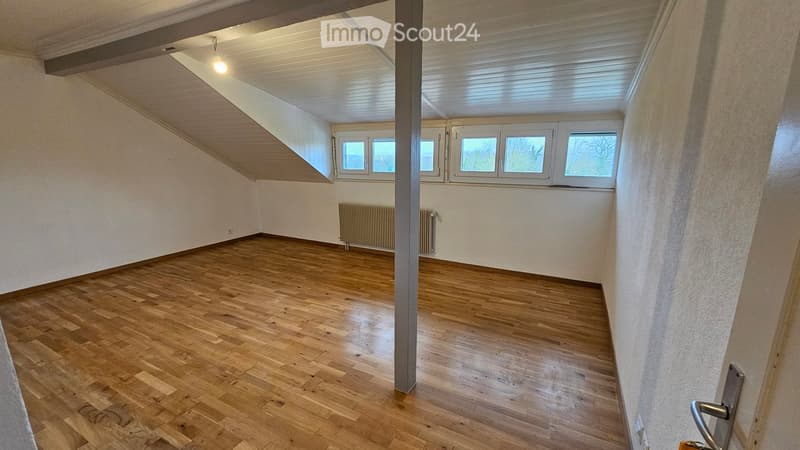 Empty room, hardwood flooring, white ceiling, white walls, 3 windows, radiators, view from windows