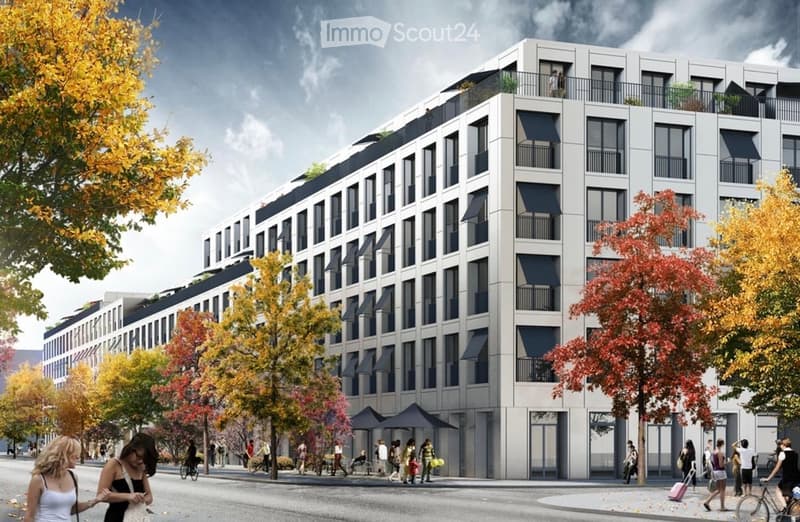 Modern multi-story apartment building with balconies and large windows, surrounded by trees and pedestrians on a city street.