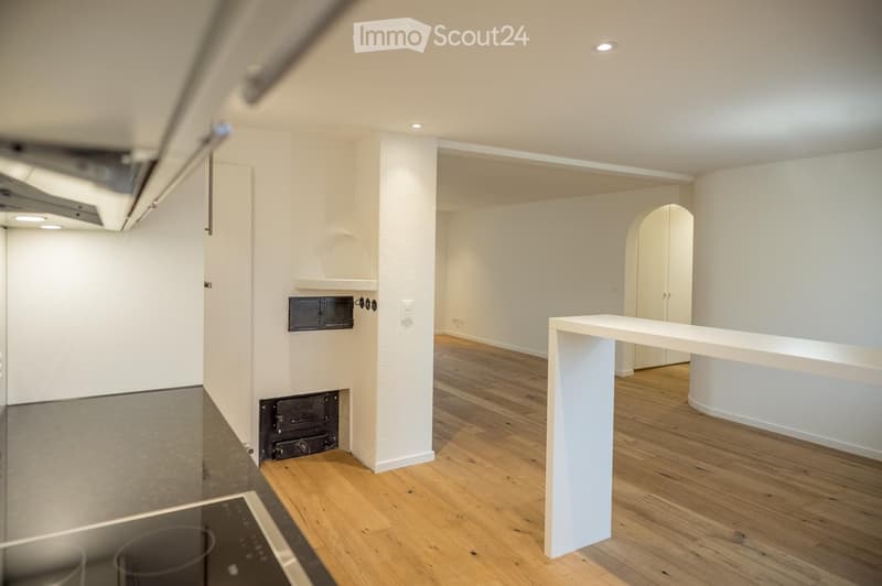 Empty room with white walls, wooden flooring, and built-in cabinets. No furniture or appliances are present.