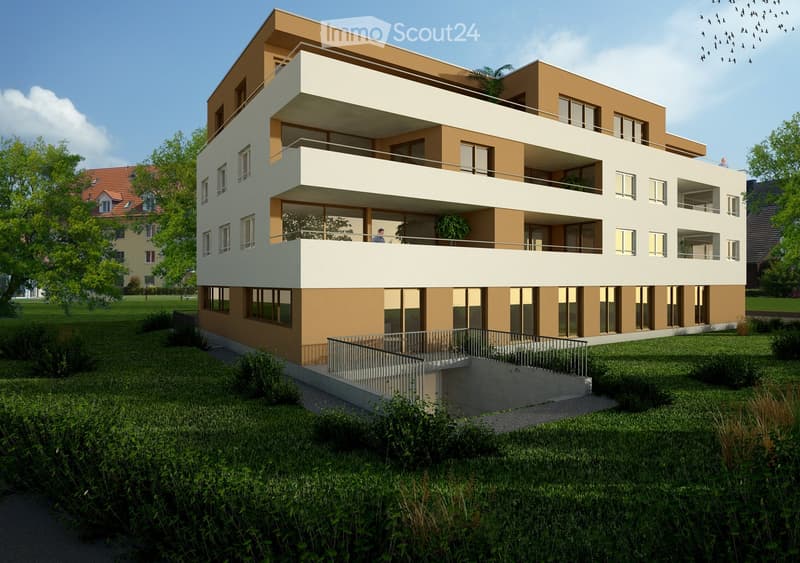Modern two-story building with beige and white facade, multiple balconies, large windows, and a raised ground floor entrance.
