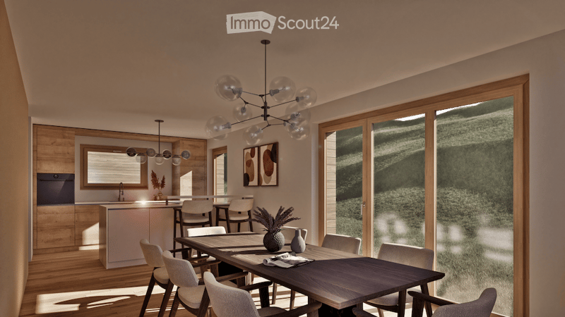Modern open-plan dining and kitchen area with wooden flooring, large windows, a dark wooden dining table surrounded by white chairs, a kitchen island with bar stools, and a chandelier with glass globes.