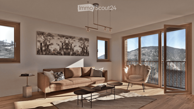 Modern living room with large windows and a view of mountains, featuring a beige sofa, coffee table, side table, and a unique chair. Artwork adorns the wall, and the space is well-lit with natural light.