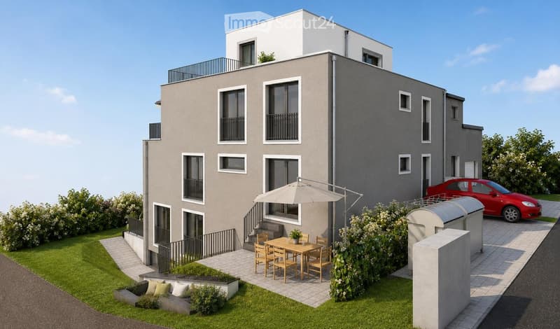 Modern two-story house with grey facade, multiple windows, balconies, and a well-maintained garden area with outdoor furniture and a parked car.