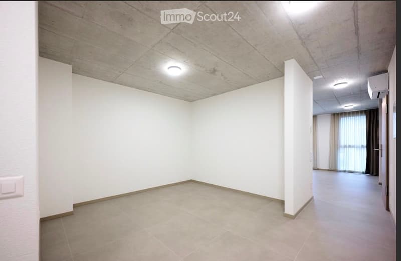 Empty room with white walls, tiled floor, and recessed lighting. No furniture or equipment present.