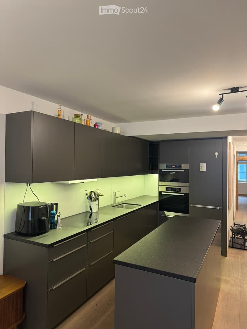 {"type": "Kitchen", "objects": ["coffee maker", "faucet", "sink", "oven", "cabinets", "countertop", "bottle", "cup", "bottle", "bottle", "bottle", "bottle", "bottle", "bottle", "bottle", "bottle", "bottle", "bottle", "bottle", "bottle", "bottle", "bottle"