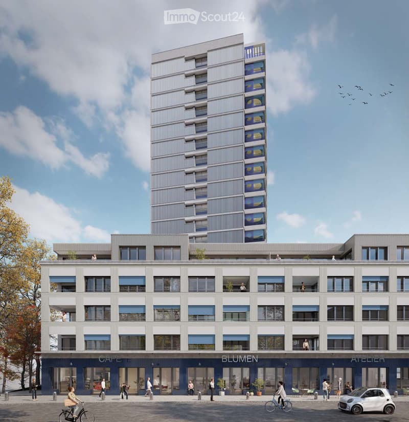 Modern multi-story building with contemporary design, featuring large windows, balconies, and commercial storefronts labeled "CAFE," "BLUMEN," and "ATELIER." The ground floor includes seating areas and bicycles.