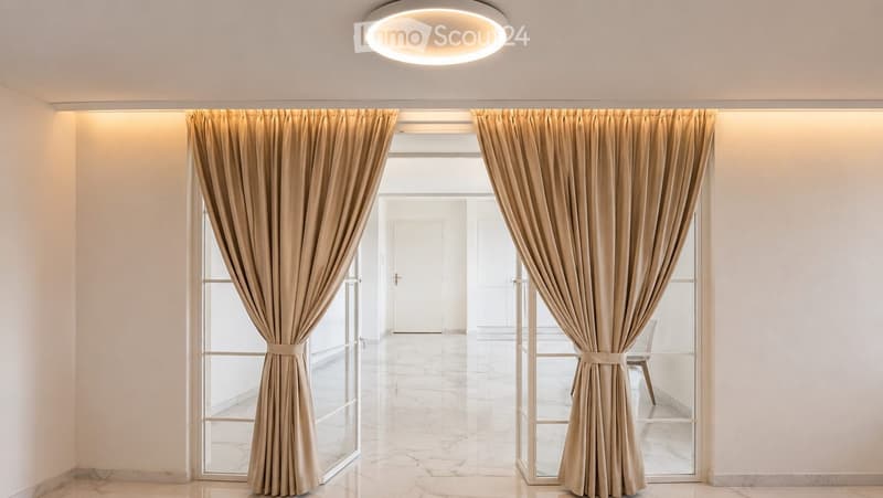 Elegant hallway with large windows, beige curtains, marble flooring, and recessed lighting.