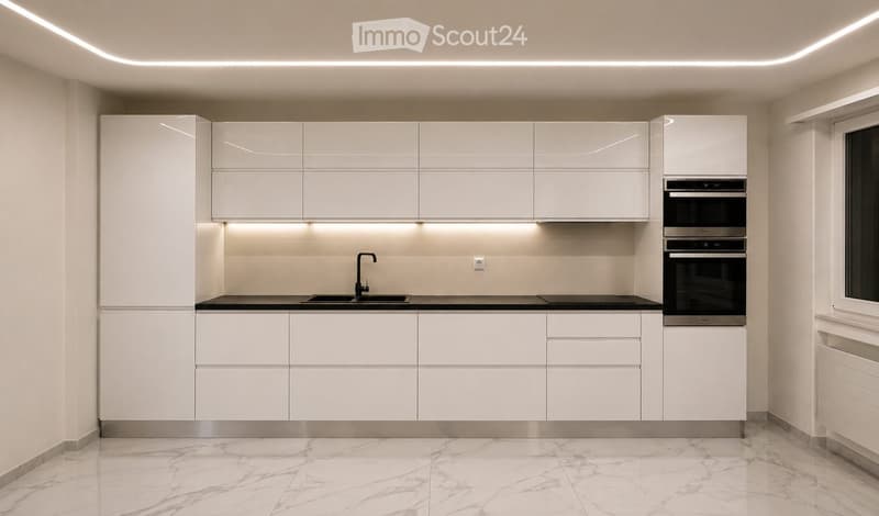 Modern kitchen with white cabinets, marble flooring, built-in oven, and sleek lighting.
