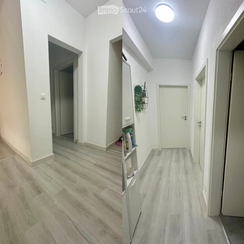 Clean, modern hallway with light-colored wooden flooring, white walls, and several doors leading to different rooms.