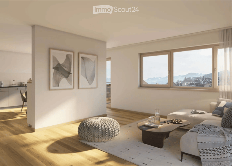 Bright living room with large windows offering a scenic view, featuring a white sofa, coffee table, round stool, and framed artwork on the wall.