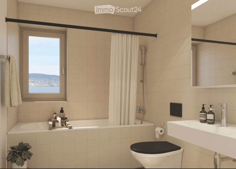 Modern bathroom with beige tiles, a bathtub, toilet, sink, and a large window offering a scenic view.
