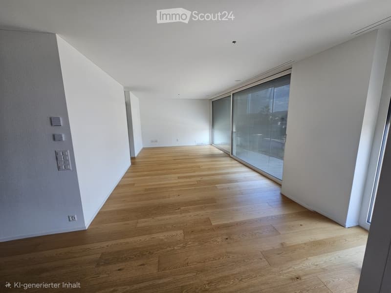 Empty room with light wooden flooring, white walls, and large glass sliding doors leading to an outdoor area.