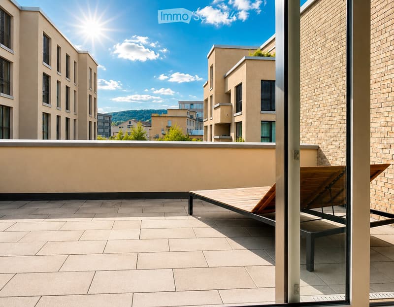 Balcony with tiled floor, sun lounger, and view of modern buildings and greenery.