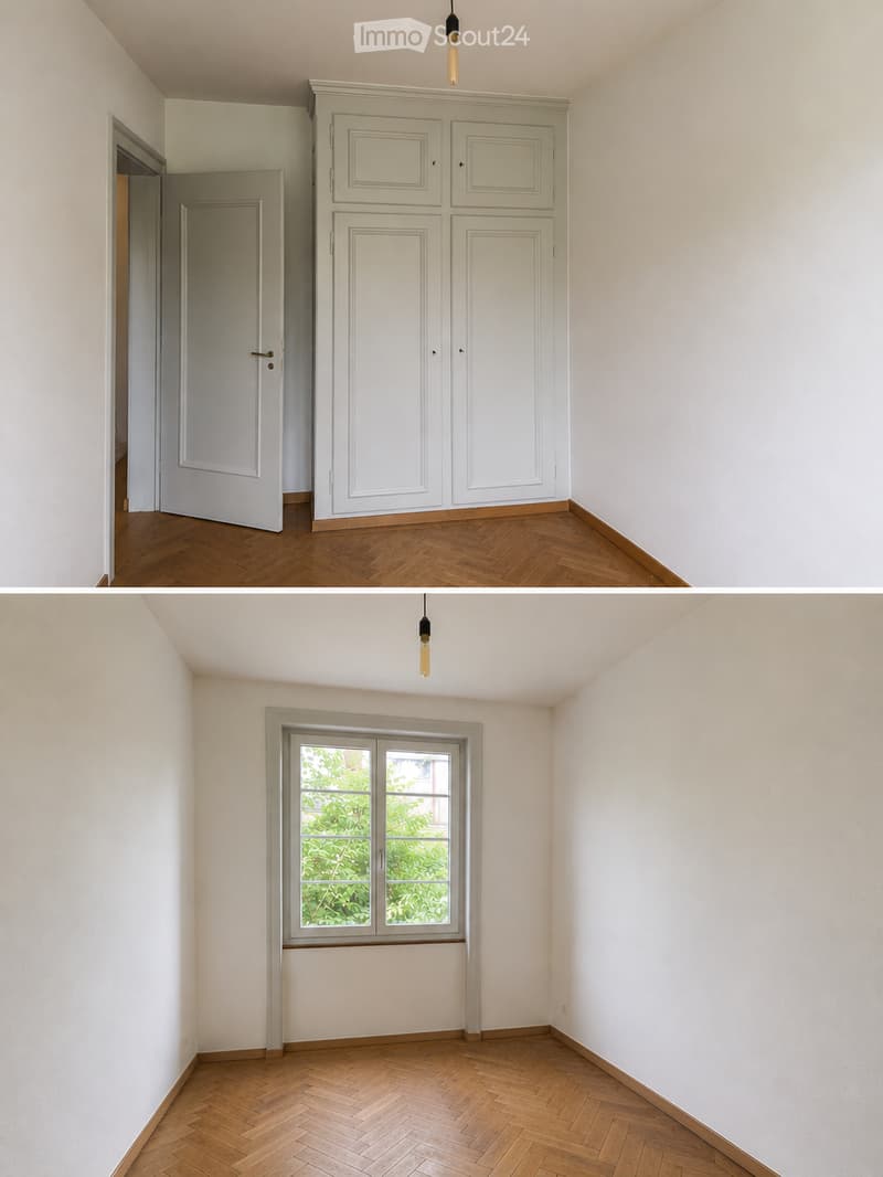 Empty room with wooden herringbone flooring, white walls, built-in cabinetry, and a window with a view of greenery.