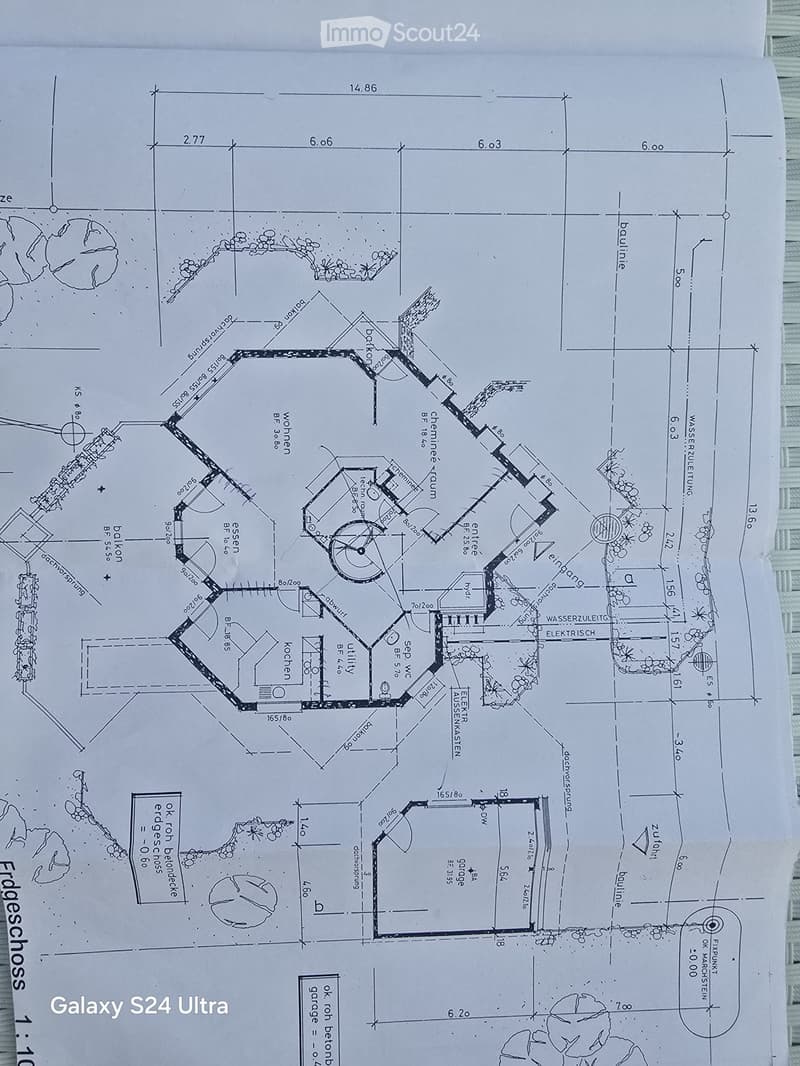 Floor plan of a house showing living room, kitchen, bedrooms, bathrooms, and utility area. Includes measurements and labels for various rooms and spaces.