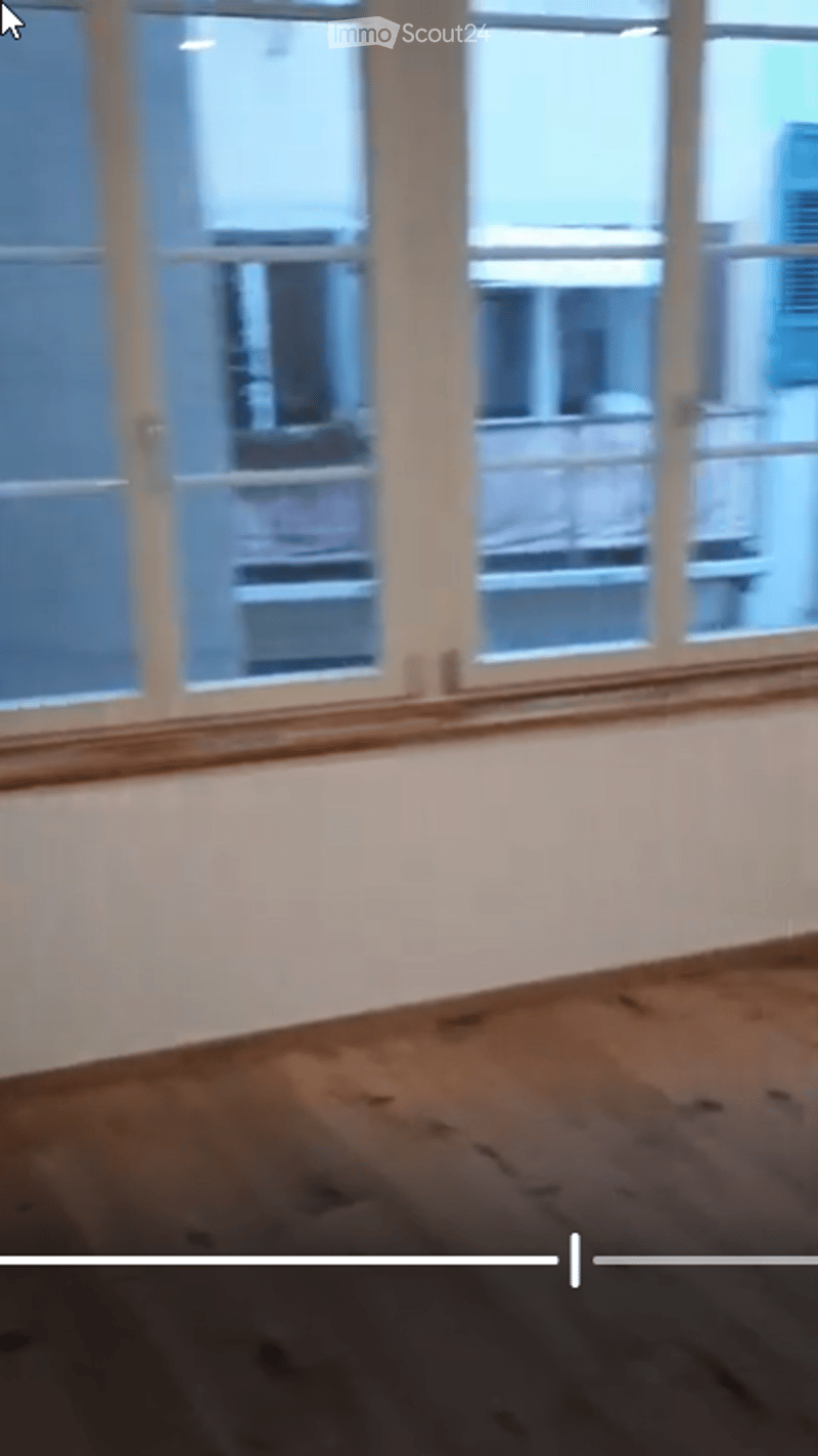 Empty room with wooden flooring and large windows, no furniture or equipment present.