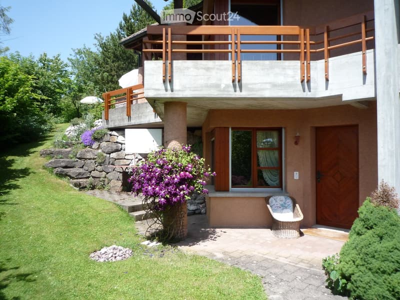 2 story house, balcony, wooden door, stone wall, flower pot, grassy lawn