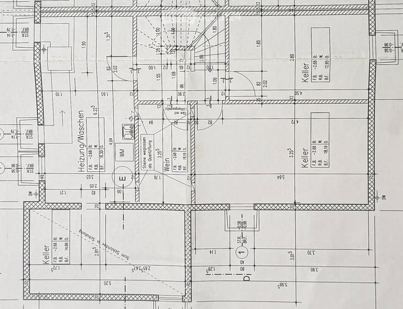 Floor plan showing a multi-level building layout with labeled rooms including a heating/washing area, cellar, and various dimensions.