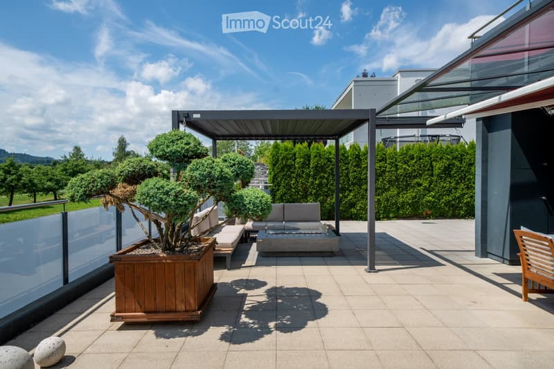 covered patio with a wooden pergola, sitting area, and a firepit with seating