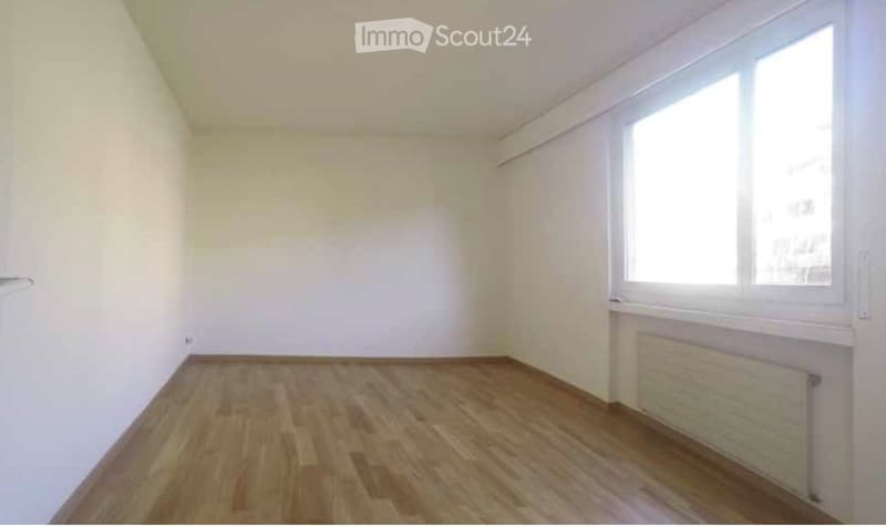 Completely empty room with bare white walls and wooden floor. No furniture or equipment.