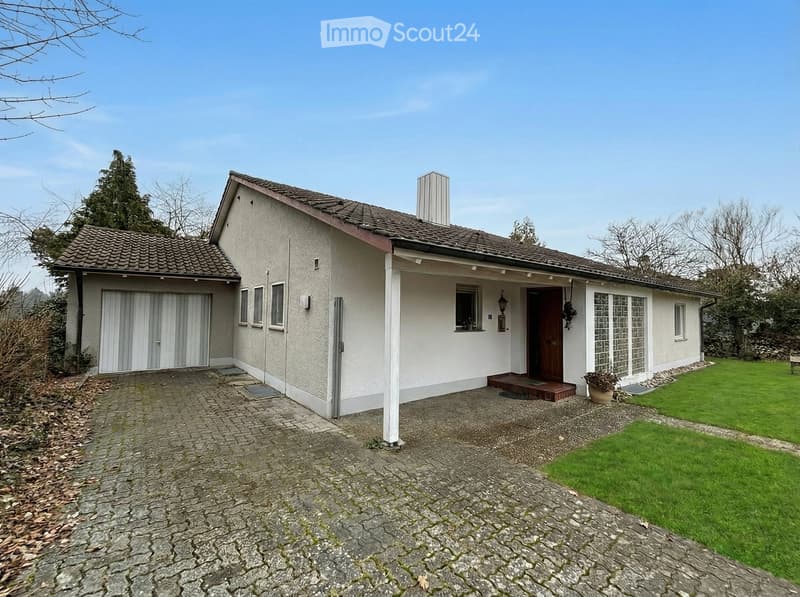 Detached house, white exterior, brown roof, double garage, paved driveway, front porch, garden, chimney