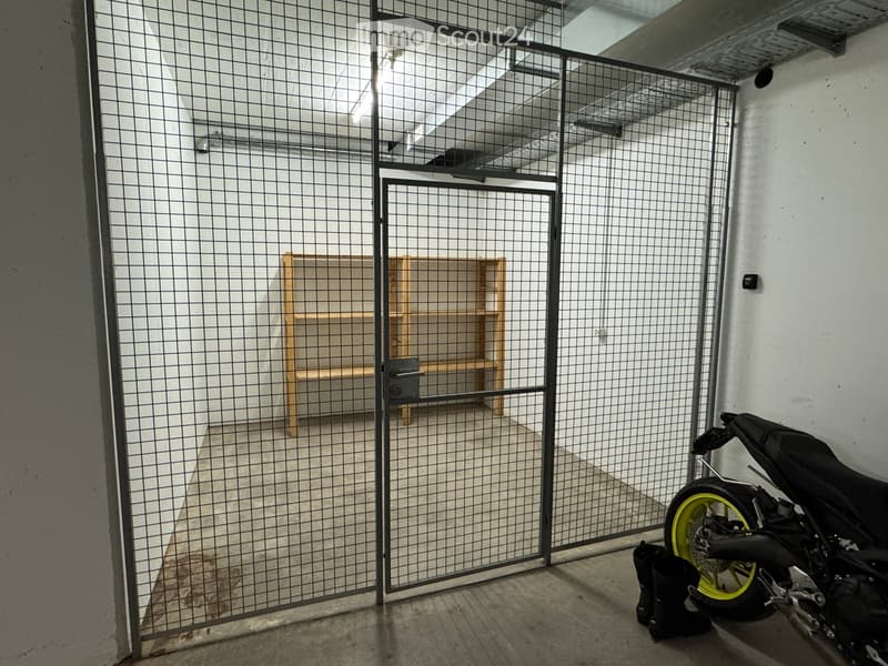 A modern, industrial-style garage with a metal gate, a wooden shelf, a parked motorcycle, and a pair of black boots.
