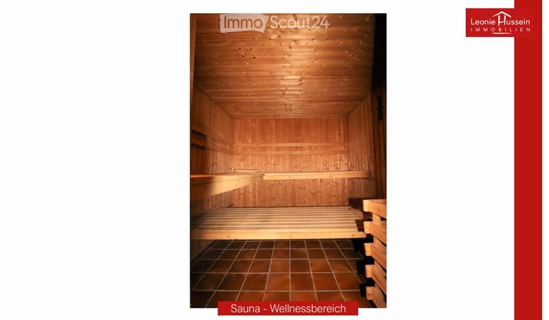 A wooden sauna with wooden benches and a tiled floor, part of a wellness area.