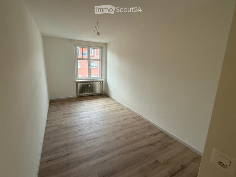 empty room, wooden floors, white walls, window, radiator