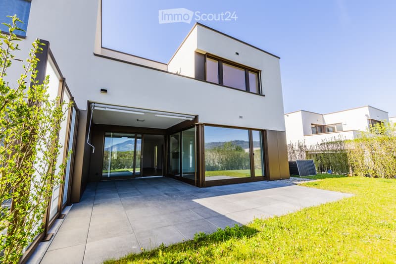 modern house, white exterior, large glass doors, balcony, paved entrance, green lawn