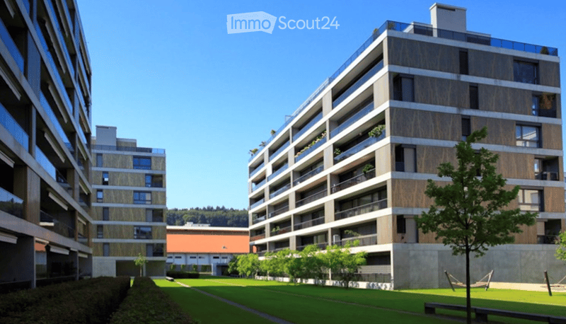 Apartment complex, modern architecture, balconies, green areas, landscaped lawn