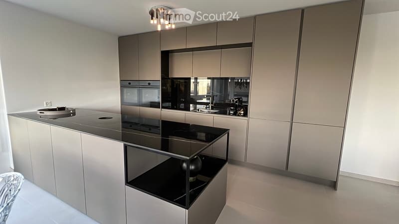central island with glass countertop, built-in oven and dishwasher, modern cabinets, white tiled floor, pendant lighting