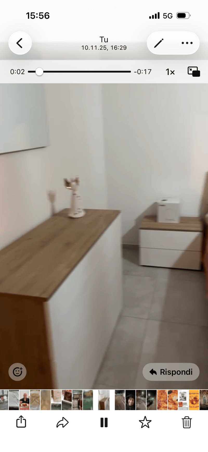 Empty room with white walls, wooden floor, and a small wooden shelf with a decorative item on it.