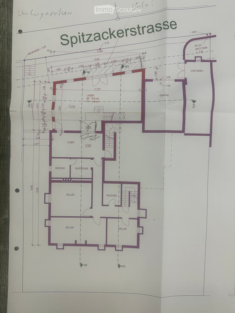 Floor plan of a building showing multiple rooms including a garage, storage areas, and basement spaces.