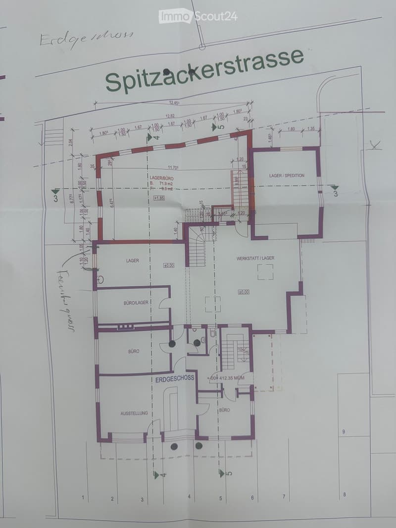 Floor plan of a commercial building with labeled areas including offices, storage, workshop, and exhibition space. Dimensions and room labels are visible.