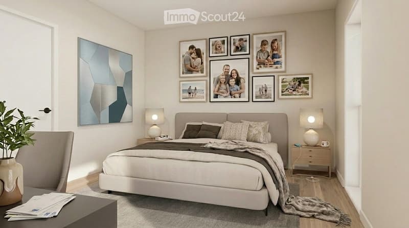 Modern bedroom with a large bed, nightstands, lamps, picture frames, and a plant. The room features light-colored walls and wooden flooring.